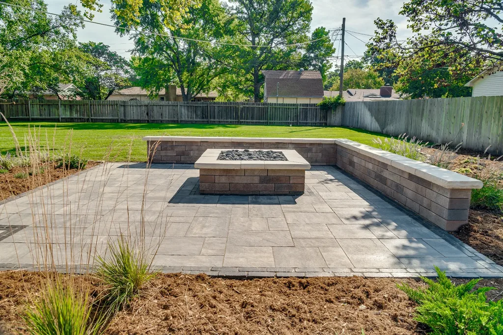 Backyard patio with firepit and retaining wall